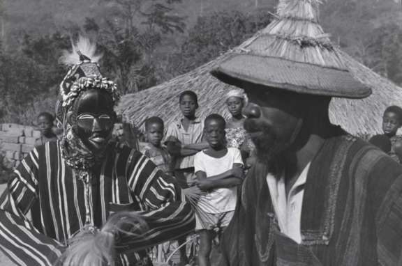 A tanka mask dances with its owner. Côte d’Ivoire, village of Bagamaplö. © Eberhard Fischer​​​​​​​