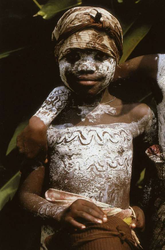 Young Bassa woman from River Cess covered in kaolin paint. © Charles D. Miller III